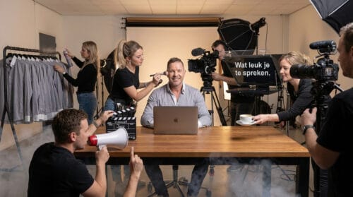 Jacy Toetenel zit klaar voor een strategiegesprek met een complete filmcrew die hem helpt - knipoog naar het filmen van een videocall