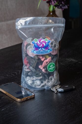 Sfeerfoto van een zak veganistische drop op een donkere tafel
